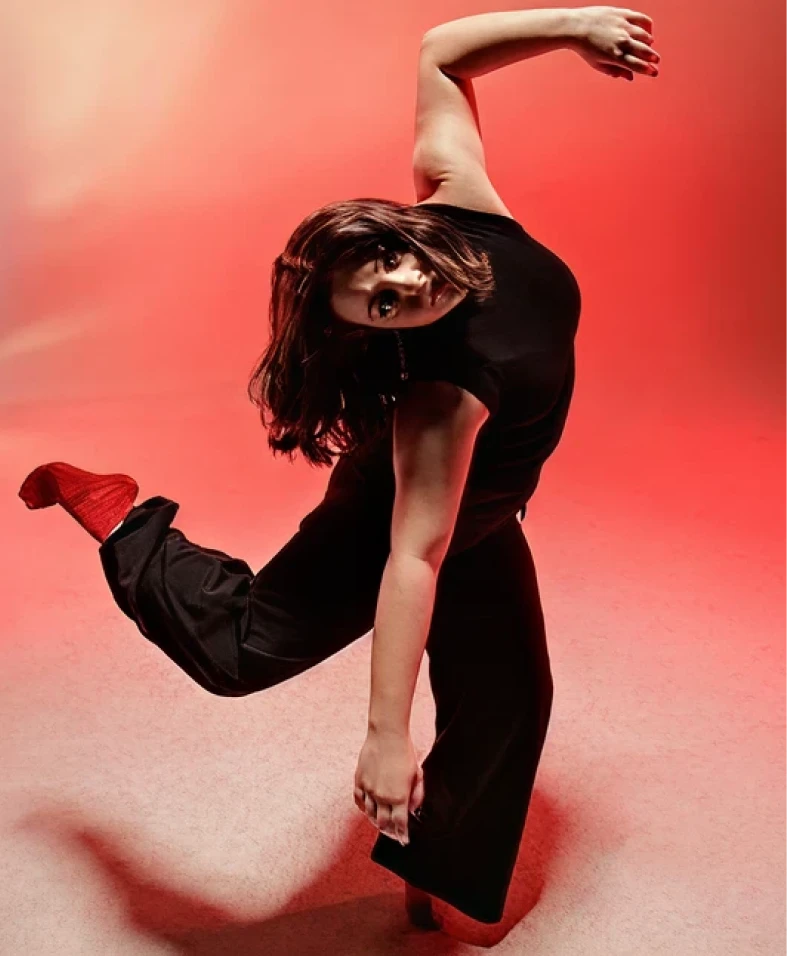 Dancer in dynamic pose on red background