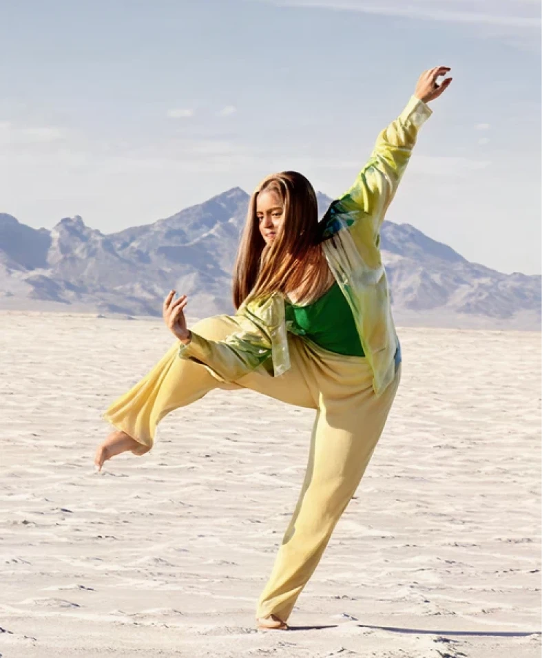 Woman dancing in desert landscape