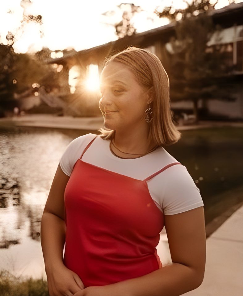Smiling woman outdoors at sunset