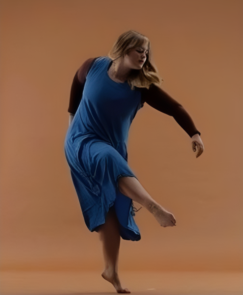 Woman dancing barefoot on orange background